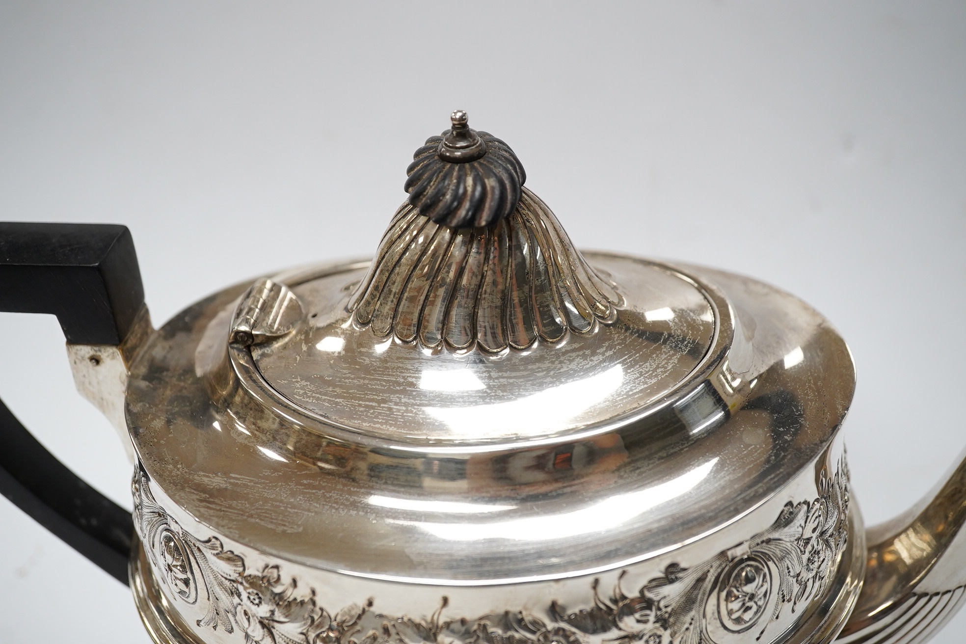 A late Victorian silver half fluted and floral embossed teapot, John Round & Sons, Sheffield, 1895, gross weight 22.8oz. Condition - poor.